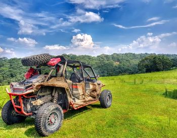 Tractor on field against sky