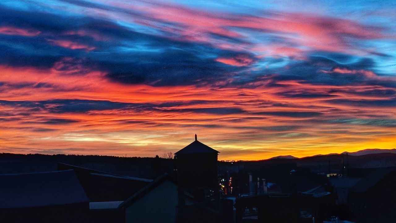 SILHOUETTE BUILDINGS AGAINST ORANGE SKY