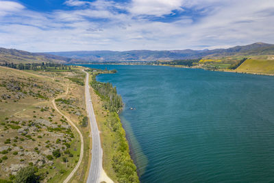 Panoramic shot of road by sea against sky