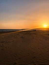 Scenic view of beach against sky during sunset
