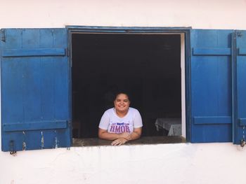 Portrait of woman seen from window