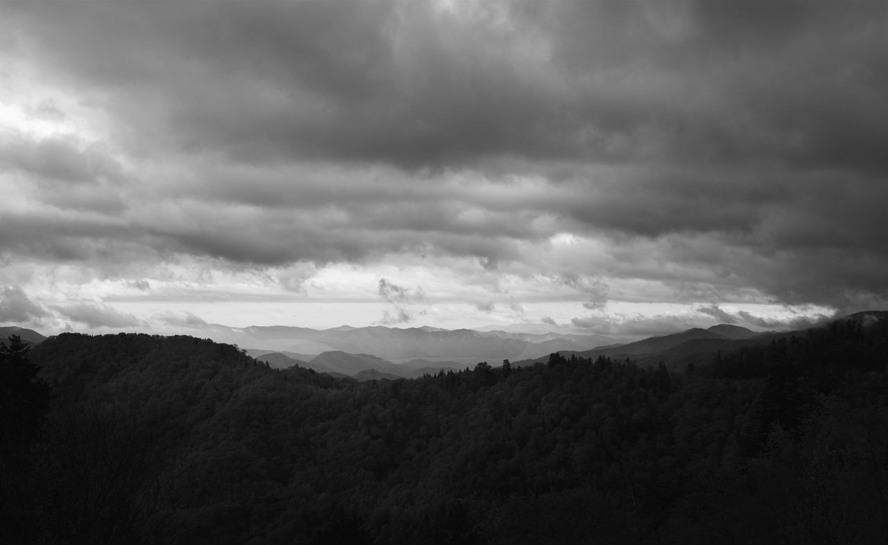 sky, cloud - sky, mountain, cloudy, tranquil scene, scenics, tranquility, landscape, weather, beauty in nature, mountain range, nature, cloud, overcast, electricity pylon, non-urban scene, silhouette, storm cloud, fuel and power generation, outdoors