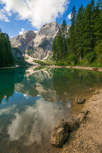 Scenic view of lake by mountain against sky