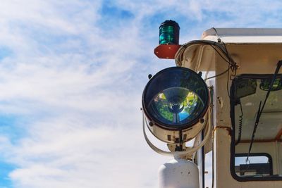 Low angle view of illuminated lighting equipment against sky