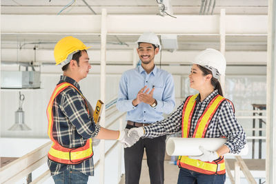 Engineer clapping by colleagues handshaking at site