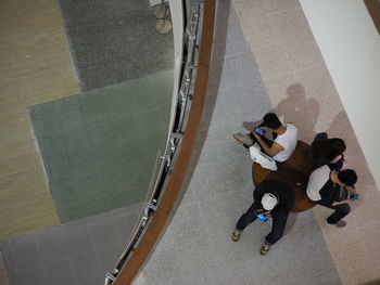 High angle view of people sitting on seat in mall
