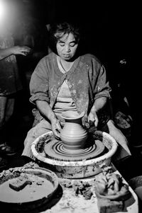 Woman making pottery in workshop