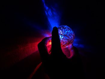 Person holding illuminated light painting