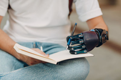 Close-up of man working on book