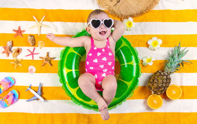 Low section of woman wearing sunglasses on table