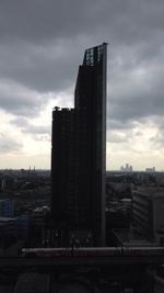 Cityscape against cloudy sky