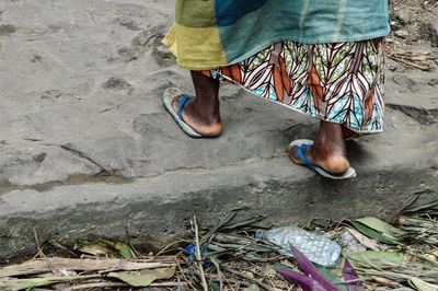 Low section of woman standing on land