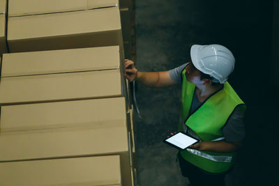 Man working against wall