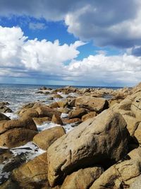 Rocks on beach against sky