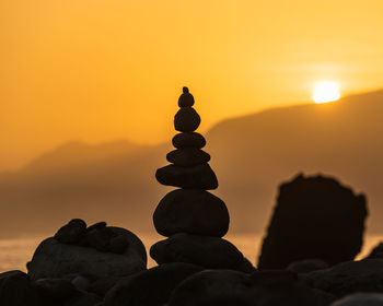 Heap of stones near sea at sunrise. ribeira da janela, madeira