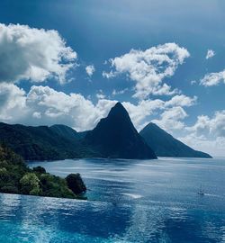 Scenic view of sea and mountains against sky