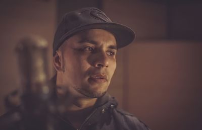 Close-up portrait of young man wearing hat