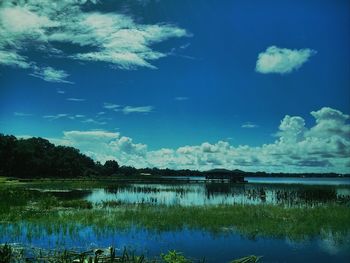 Scenic view of lake against cloudy sky