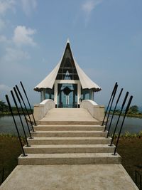 Staircase by sea against sky