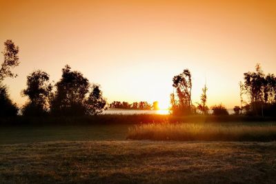Scenic view of field against sky during sunset