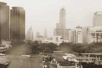 Buildings in city against sky