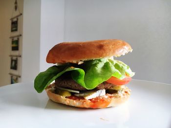 Close-up of burger on white table