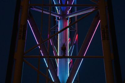 Low angle view of illuminated bridge against sky at night