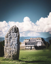 Old ruins on field against sky