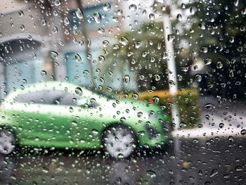 Full frame shot of wet glass window in rainy season