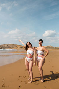 Full length of woman on beach against sky