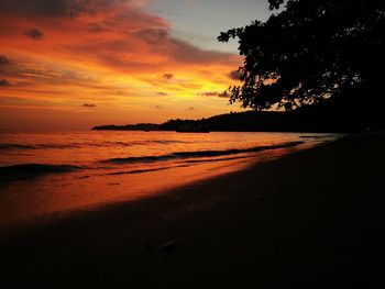 Scenic view of beach against sky during sunset