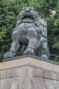 Low angle view of statue against plants