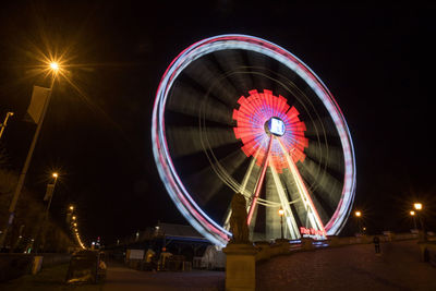 Low angle view of illuminated ferris wheel at night