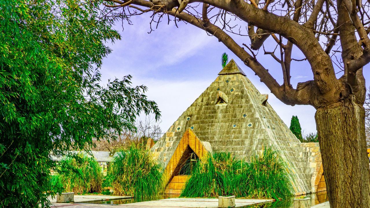 tree, plant, built structure, architecture, sky, building exterior, nature, religion, no people, belief, spirituality, place of worship, building, day, growth, green color, cloud - sky, outdoors, travel destinations, ancient civilization