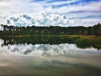 Scenic view of calm lake against cloudy sky