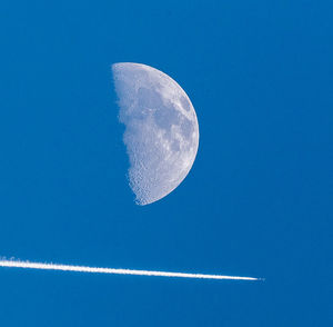 Close-up of moon against blue sky