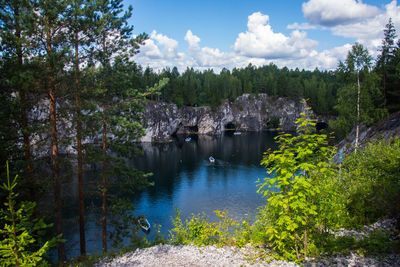 Scenic view of river against cloudy sky