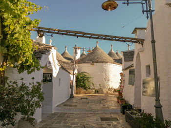 Low angle view of buildings, trulli of alberobello, apulia, against sky