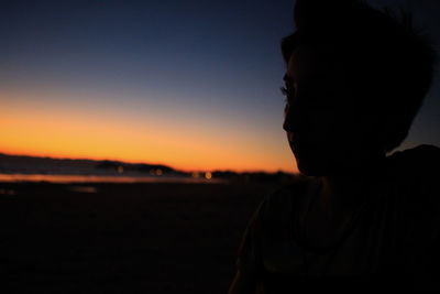 Close-up portrait of silhouette man against sky during sunset