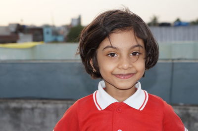 Portrait of smiling girl standing outdoors