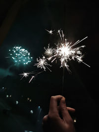 Low angle view of firework display at night