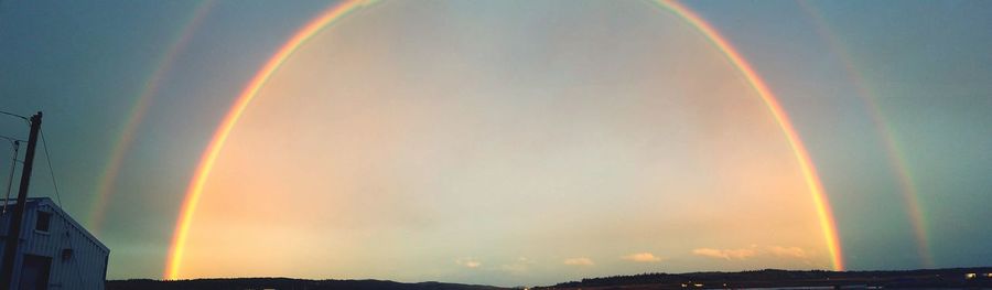 Low angle view of rainbow against sky during sunset