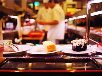 Sushi served in plates on kitchen platform