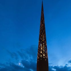 Low angle view of modern contemporary sculpture against sky