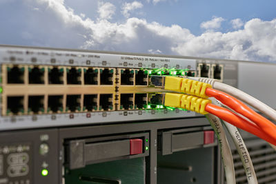 Close-up of cables in equipment against sky