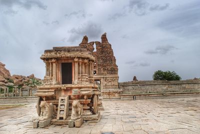View of old temple against cloudy sky