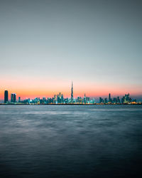 City at waterfront against sky