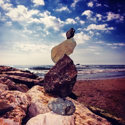 Rocks on beach against sky