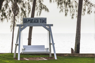 White wooden swings on the lawn at thap sakae beach prachuap khiri khan, thailand