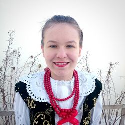 Portrait of smiling young woman standing in snow